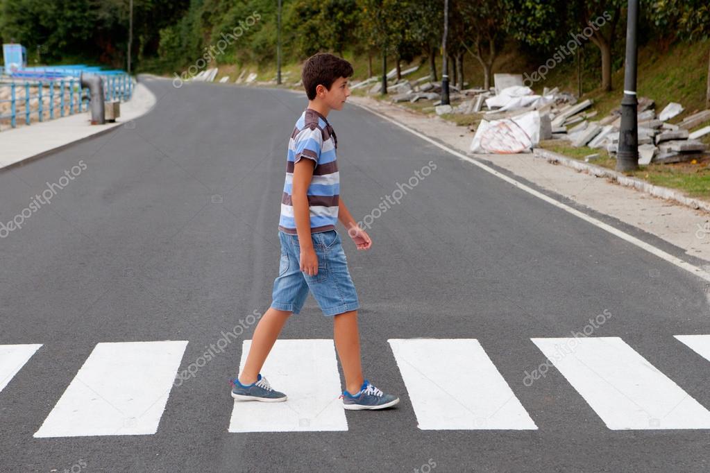 Teenager through a zebra crossing
