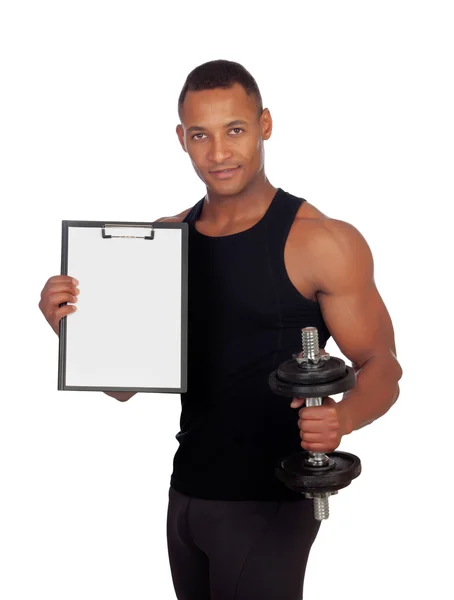 Handsome muscled man training with dumbbells and clipboard in bl — Stock Photo, Image