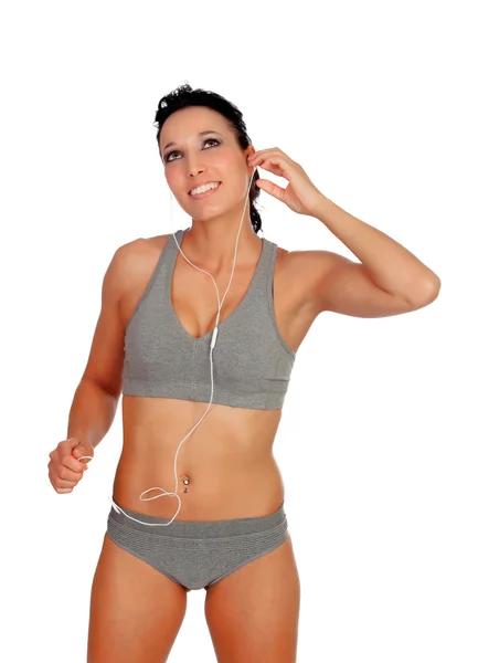 Mooie vrouw met fitness kleding luisteren muziek met headphon — Stockfoto