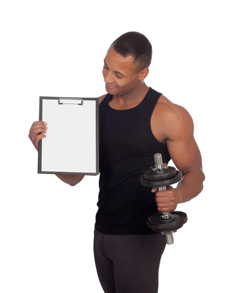 Handsome muscled man training with dumbbells and clipboard in bl — Stock Photo, Image