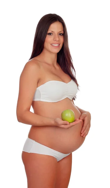 Brunette zwanger in ondergoed met een groene appel — Stockfoto