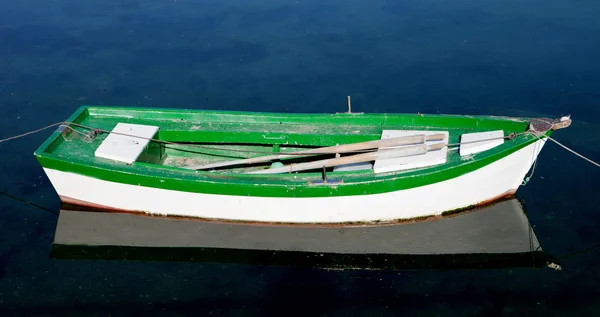 Lone barco verde e branco em um mar calmo — Fotografia de Stock