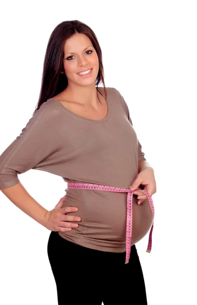 임신한 여 자가 그녀의 배꼽을 측정 — 스톡 사진