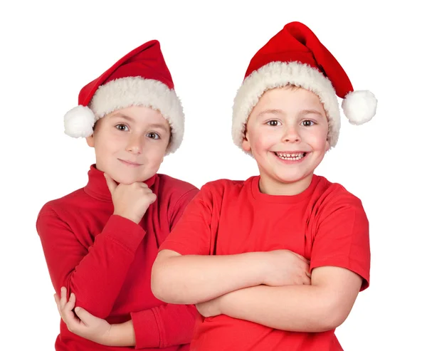 Duas crianças com chapéus de Natal — Fotografia de Stock