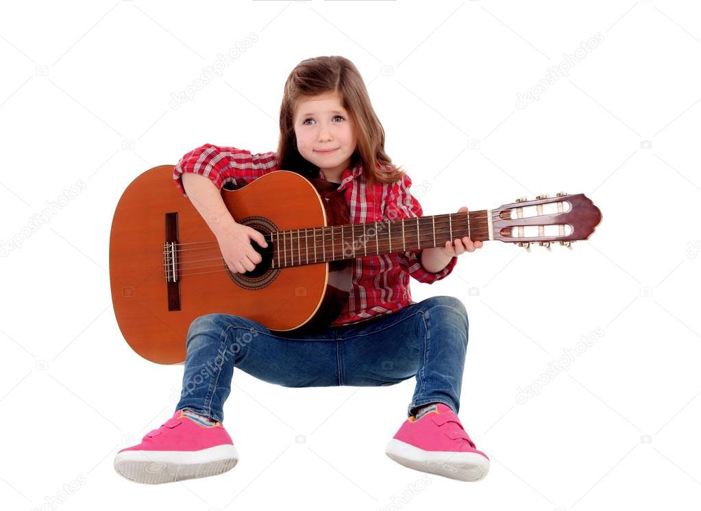 Adorable little girl playing guitar 