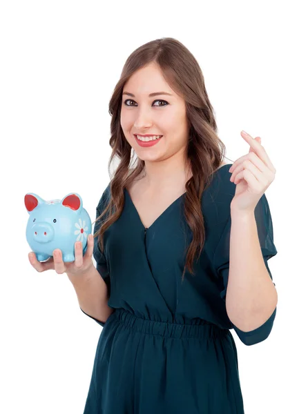 微笑的年轻女孩与一个蓝色的存钱罐 — 图库照片