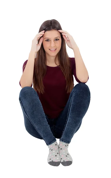 Verrast jonge vrouw zittend op de vloer — Stockfoto