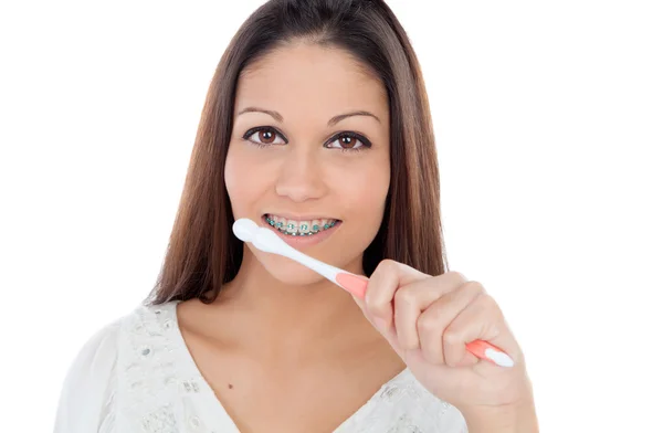 Attractive young woman with brackets cleaning her teeth — Stock Photo, Image