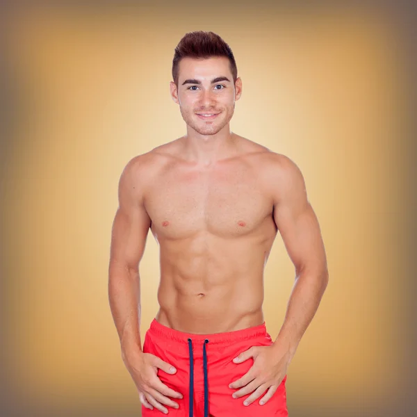 Handsome young man with red swimsuit — Stock Photo, Image