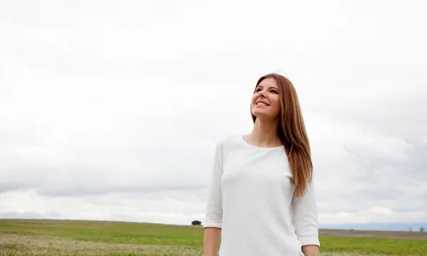 Pensive pretty woman relaxed on the meadow — Stock Photo, Image