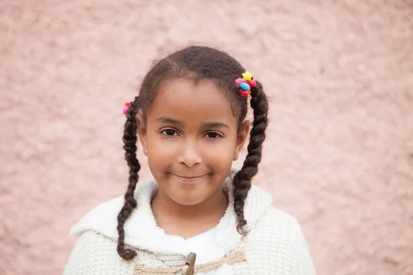 Bellissimo bambino africano con un mattone un muro rosa — Foto Stock