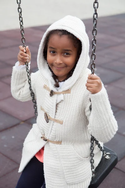 Black girl playing with a swing — Stock Photo, Image