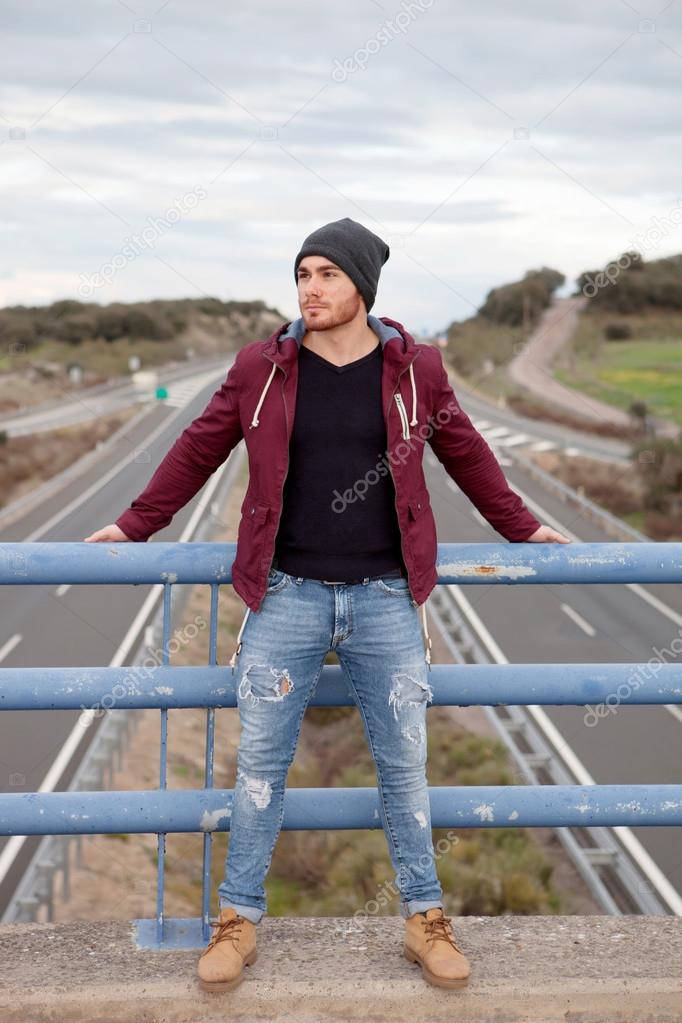 Handsome man at the top of a bridge
