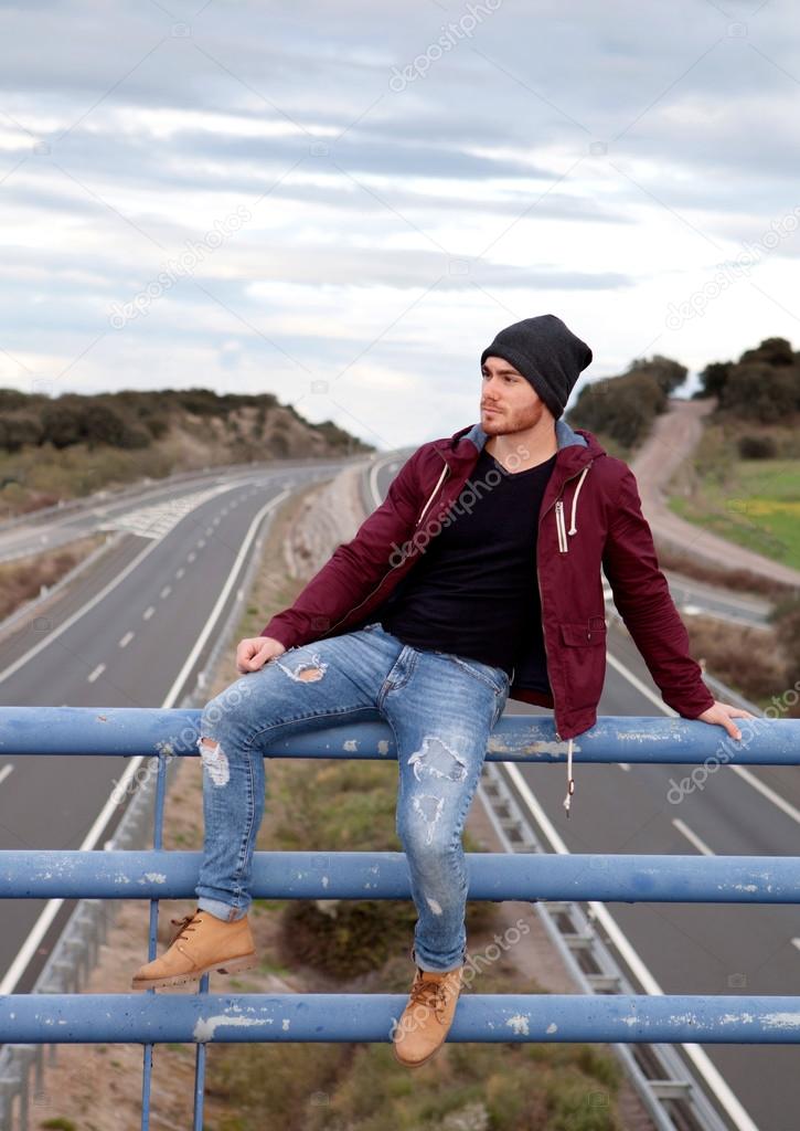 Handsome man at the top of a bridge