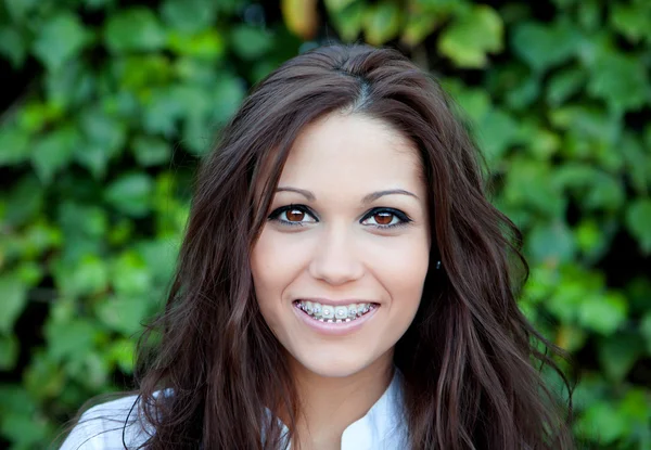 Beautiful brunette outdoors in the park — Stock Photo, Image