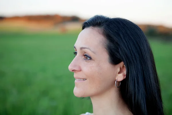 Woman looking at side relaxing on a meadow — Stock Photo, Image