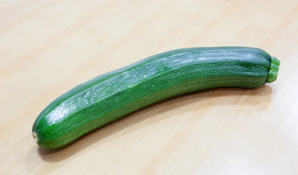 Green zucchini on a wooden surface — Stock Photo, Image