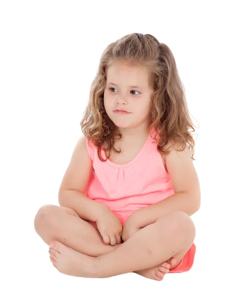 Pensiva menina sentada no chão — Fotografia de Stock