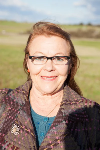 Senior woman smiling, outdoors — Stock Photo, Image