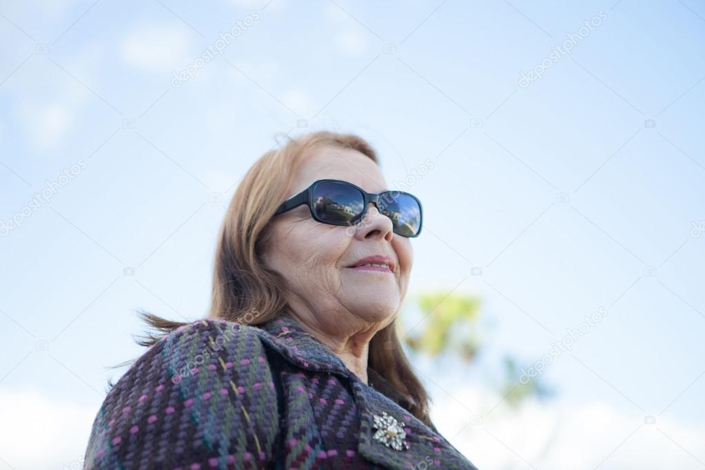 Senior woman smiling, outdoors