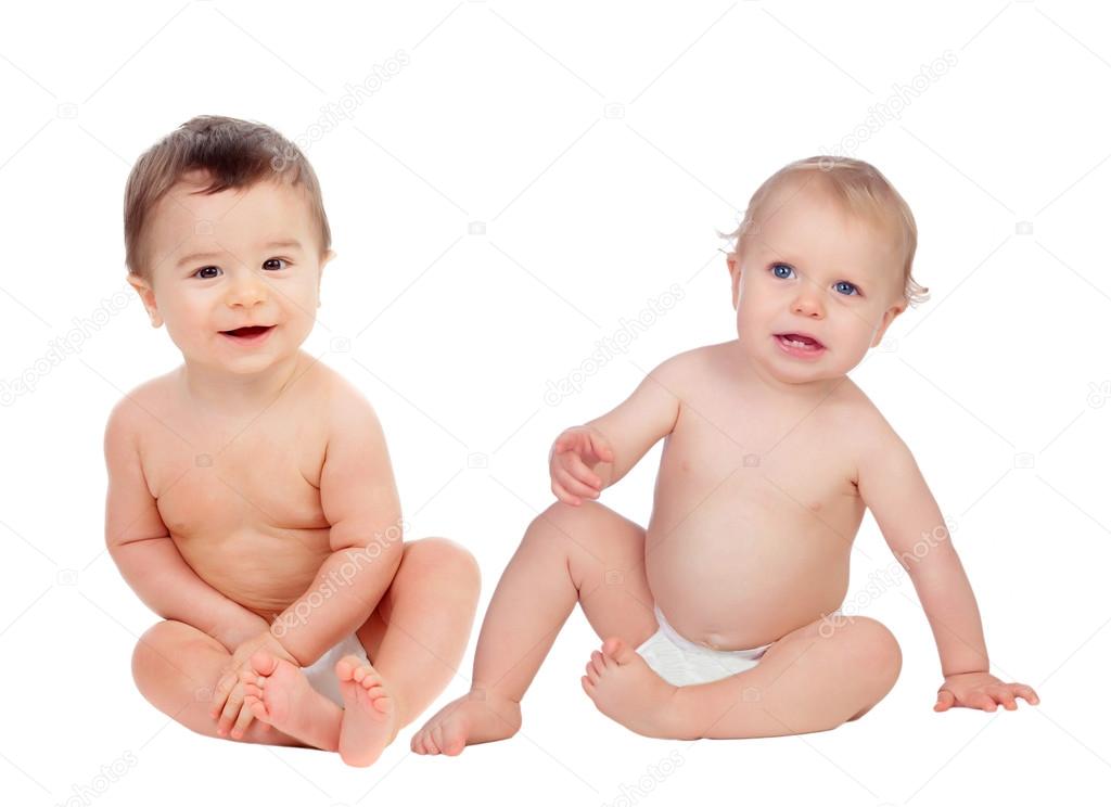 Couple of babies sitting on the floor