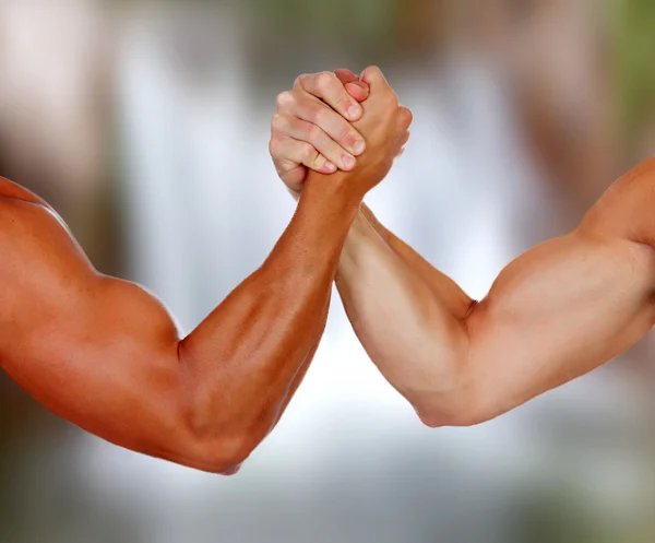 Arms with muscles taking a pulse — Stock Photo, Image