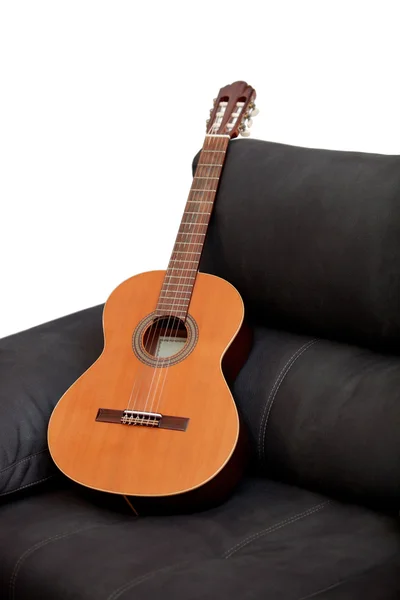 Wooden classical guitar on the sofa — Stock Photo, Image