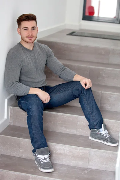 Casual man sitting on the stairs — Stock Photo, Image