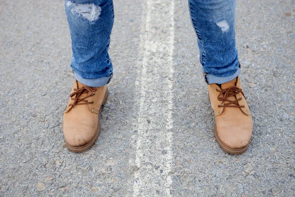 Botas velhas pisa na estrada . — Fotografia de Stock