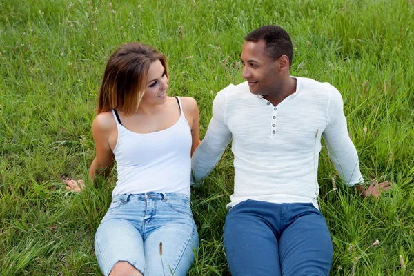 Couple lying on the grass in the field — Stock Photo, Image