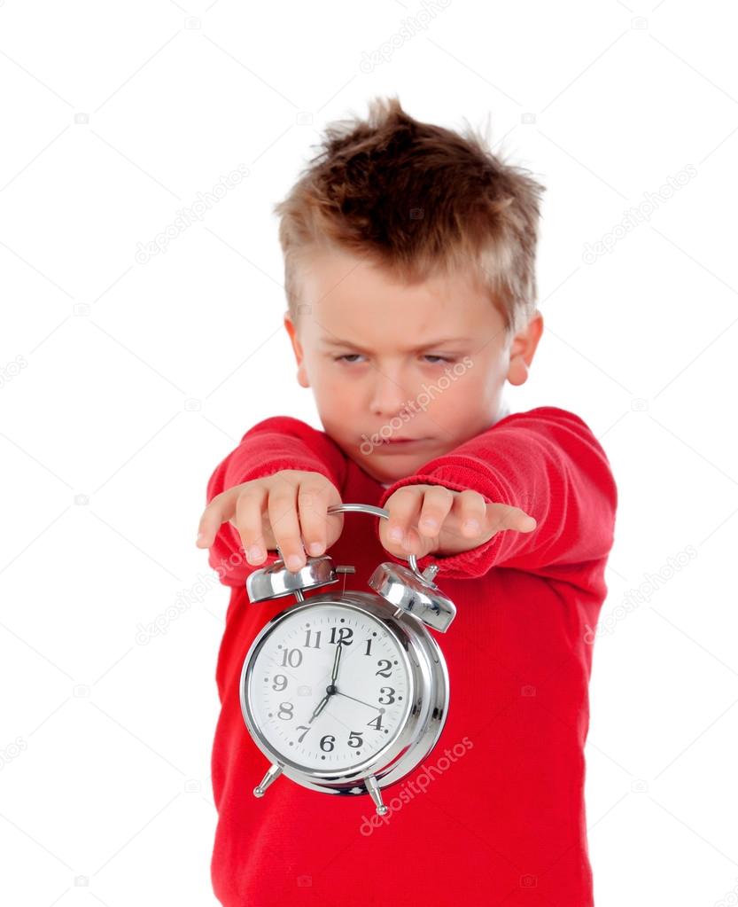 Angry little boy holding a clock  