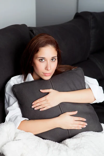 Relaxado jovem menina abraçando uma almofada — Fotografia de Stock
