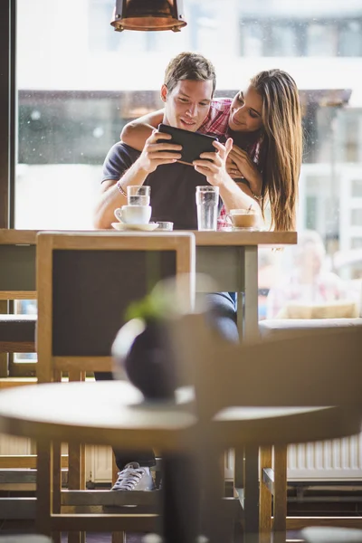 Joven pareja buscando tableta — Foto de Stock