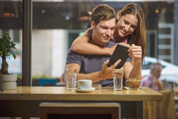 Joven pareja buscando tableta — Foto de Stock