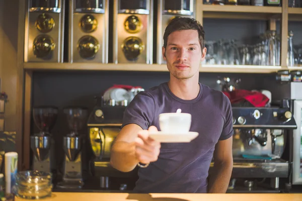 Waiter holding coffee cup — Stock Photo, Image