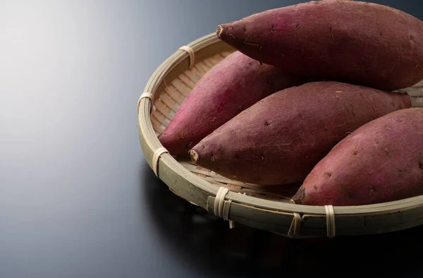 Zoete Aardappelen Een Vergiet Een Zwarte Achtergrond — Stockfoto