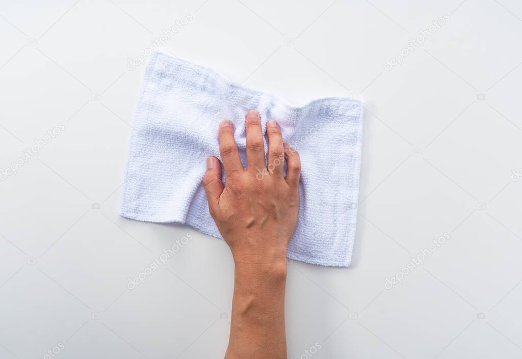 A man's hand on a white background with a rag. A view from above