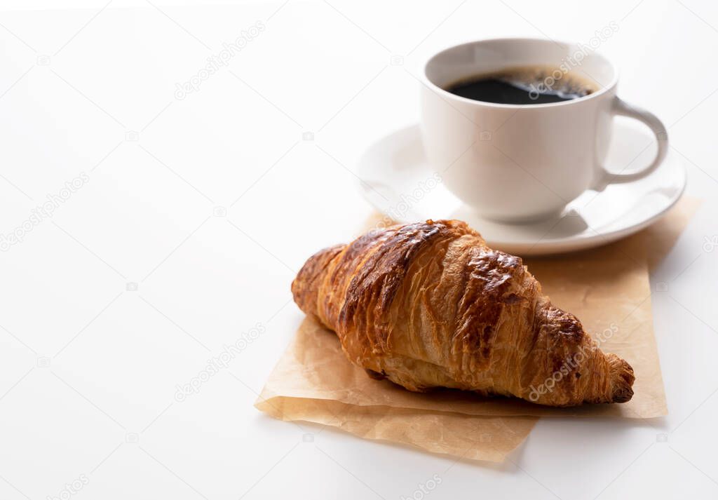 Croissants and hot coffee on a white background with a copy space