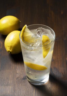 Koyu ahşap arka planda, cam sette limon ekşisi. Limon kokteyli görüntüsü