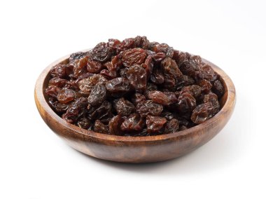 Raisins in a wooden bowl set against a white background.