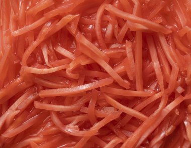 Texture of red pickled ginger. View from above.