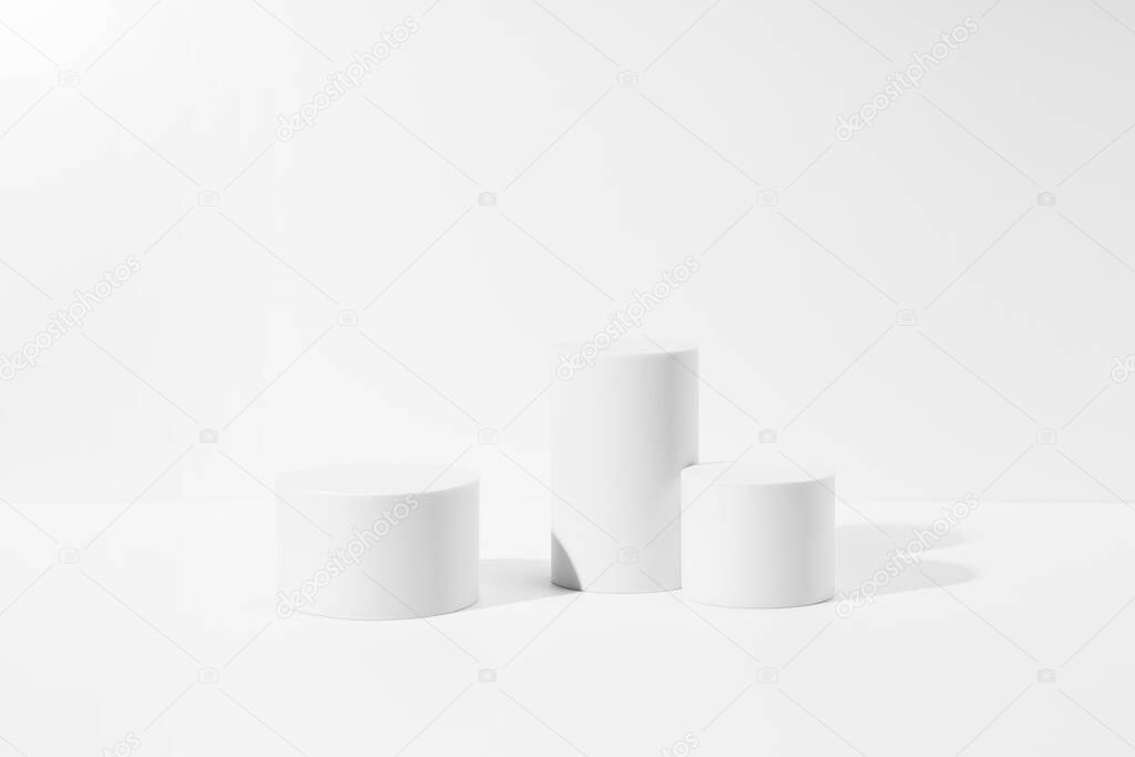 A white cylinder is placed on a white background. A stage for displaying products and cosmetics. 