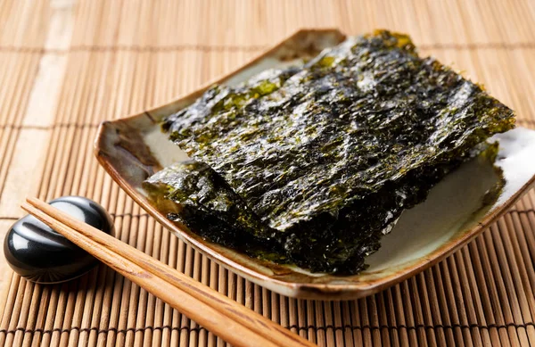 Korean seaweed served on a plate on a wooden table.