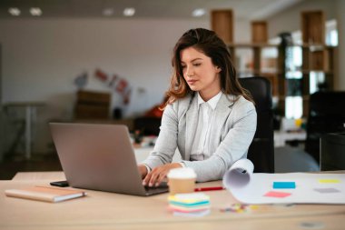 Ofiste proje üzerinde çalışan güzel bir genç kadın.