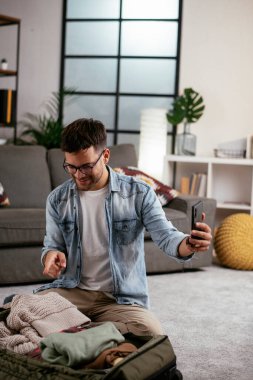 Adam yolculuğa hazırlanıyor, bavulunu hazırlıyor.