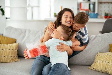 Çocuklar annelerine hediye veriyorlar.