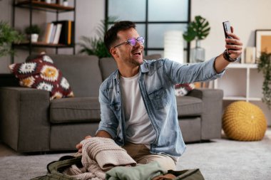 Adam yolculuğa hazırlanıyor, bavulunu hazırlıyor.