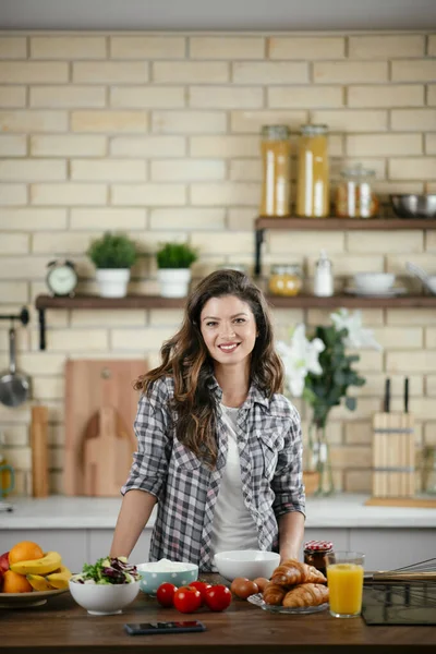 Portrait of beautiful young woman cooking in the kitchen. Young Woman Cooking. Healthy Food - Vegetable Salad.