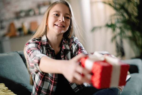 Beautiful little girl giving a present