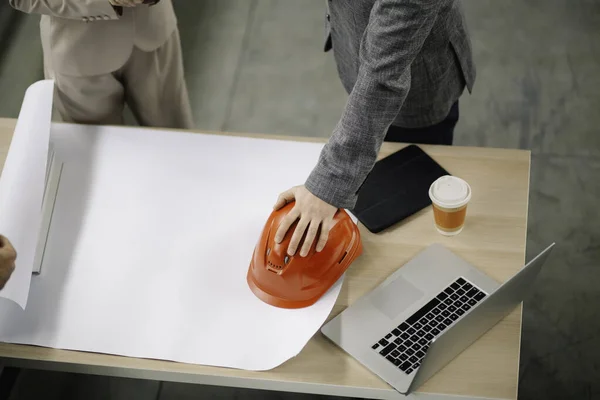 Construction Equipment Helmet Blueprints Desk Stock Photo